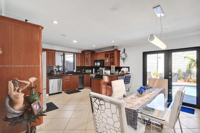 dining space with crown molding, light tile patterned floors, french doors, and a textured ceiling