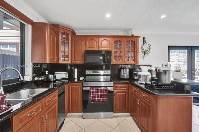 kitchen with electric range, a sink, a peninsula, black microwave, and dishwasher