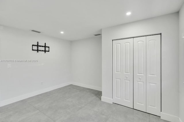 unfurnished bedroom with recessed lighting, visible vents, baseboards, and a closet