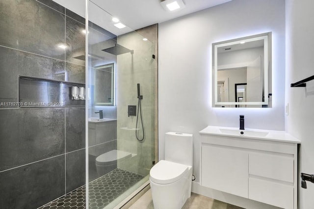 bathroom featuring vanity, toilet, and a shower stall