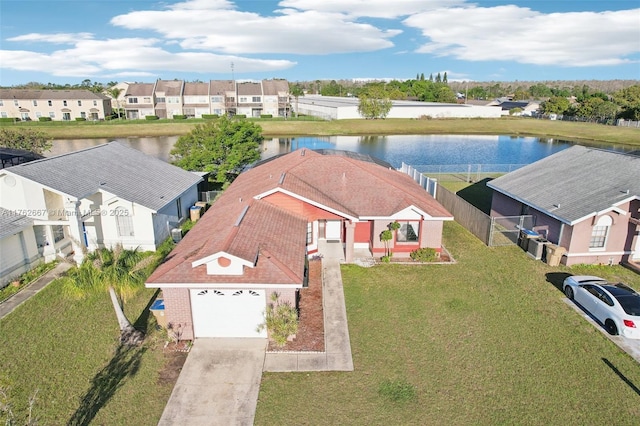 drone / aerial view with a residential view and a water view