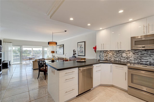 kitchen featuring dark countertops, decorative backsplash, a peninsula, stainless steel appliances, and a sink