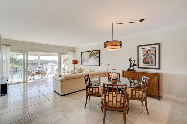 dining space with light tile patterned floors, baseboards, and ornamental molding