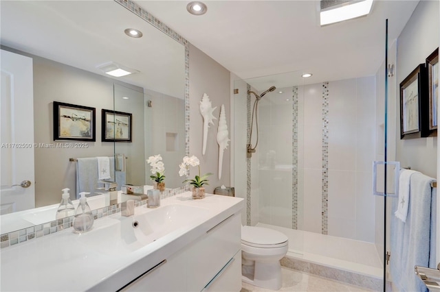 bathroom featuring recessed lighting, toilet, and a shower stall