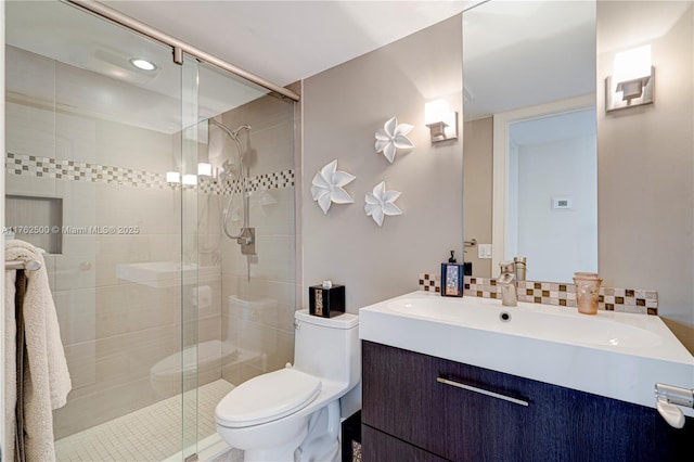 full bath with tasteful backsplash, a shower stall, toilet, and vanity