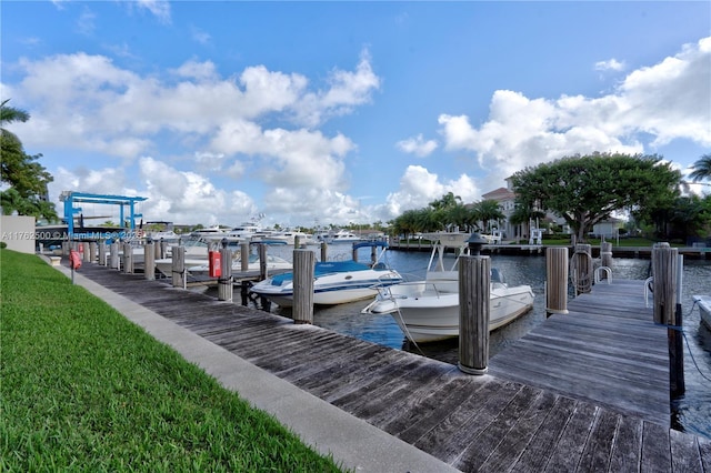 dock area with a yard and a water view