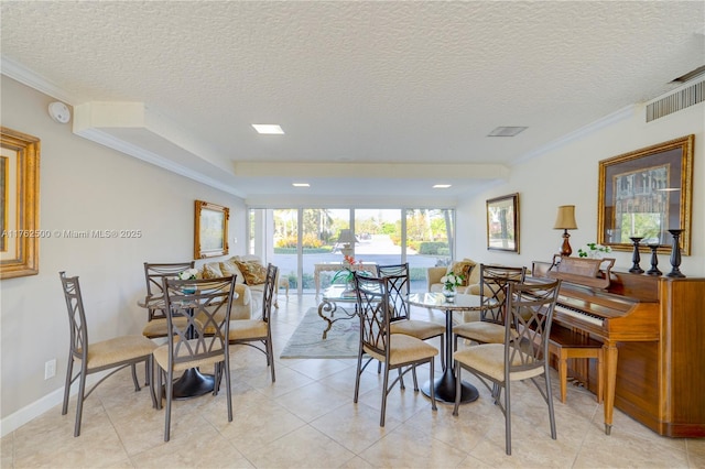 dining area with visible vents, baseboards, ornamental molding, light tile patterned floors, and a textured ceiling