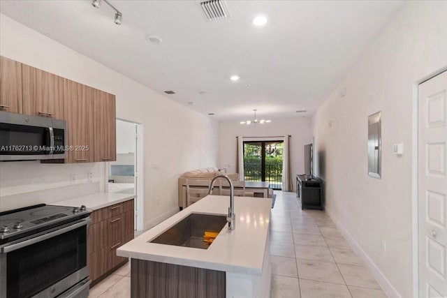 kitchen featuring open floor plan, stainless steel appliances, modern cabinets, and a sink