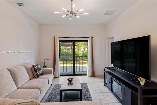 living room featuring light tile patterned floors, visible vents, and a notable chandelier