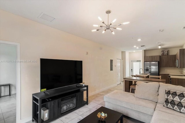 living room featuring visible vents, baseboards, light tile patterned floors, recessed lighting, and an inviting chandelier