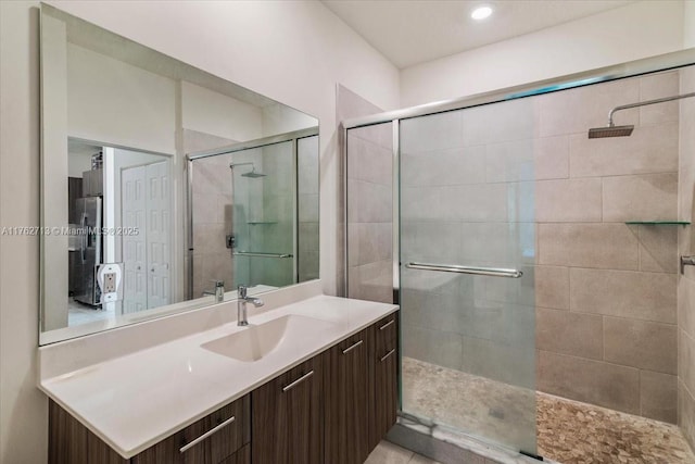 bathroom with a stall shower and vanity