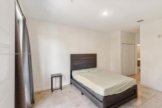 bedroom featuring visible vents, baseboards, and light tile patterned flooring