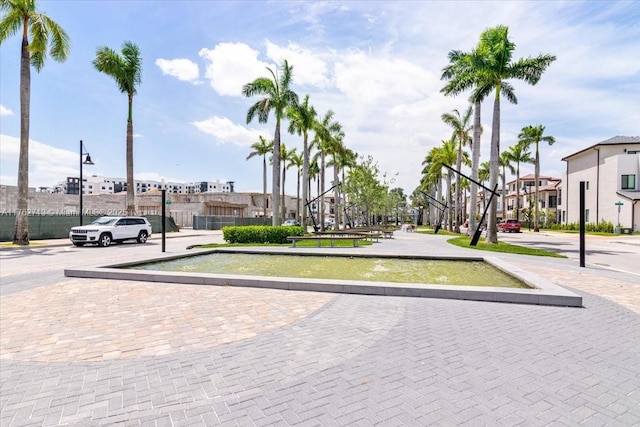 view of community with a residential view and uncovered parking