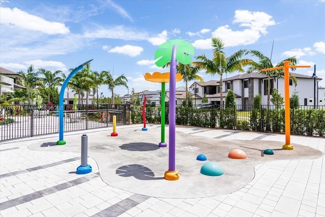 view of jungle gym with fence and a residential view