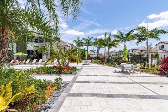 view of property's community with a patio area, fence, and a residential view