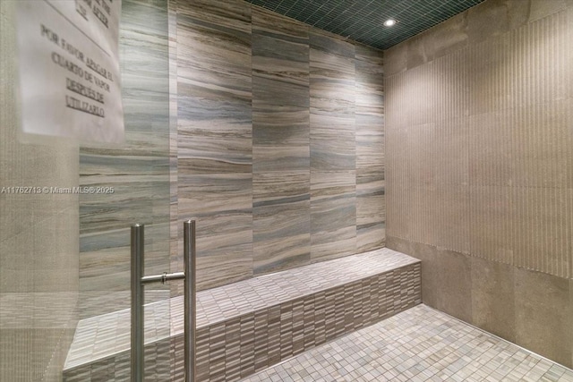 bathroom with a sauna and tiled shower