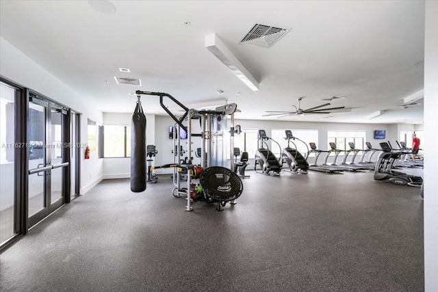 workout area with visible vents, baseboards, ceiling fan, and french doors