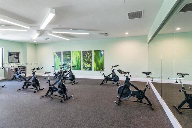 exercise room with visible vents and baseboards