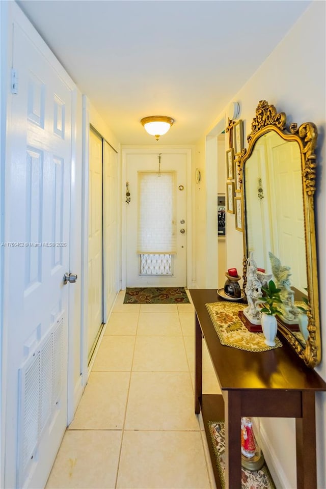 entryway featuring light tile patterned flooring and visible vents