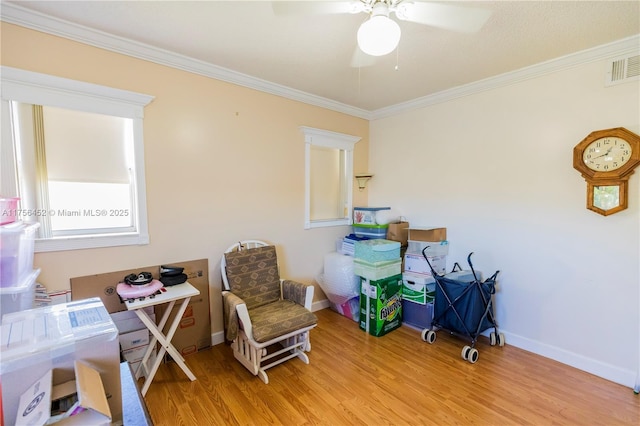 home office featuring baseboards, light wood-type flooring, ceiling fan, and ornamental molding