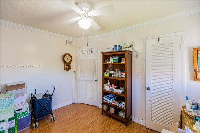 misc room featuring visible vents, a ceiling fan, light wood-style floors, and ornamental molding