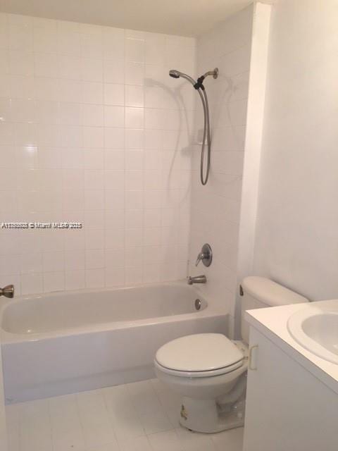 full bath with vanity, toilet, washtub / shower combination, and tile patterned flooring