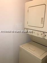 3231 Sabal Palm Mnr Unit 101, Davie, FL 33024 - laundry room featuring stacked washer and clothes dryer