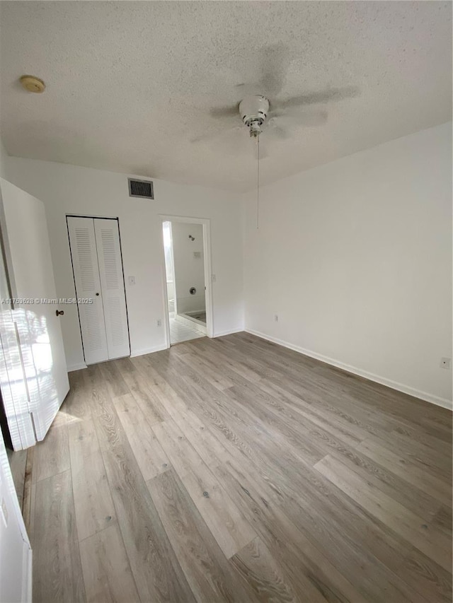 3231 Sabal Palm Mnr Unit 101, Davie, FL 33024 - unfurnished bedroom with a textured ceiling, wood finished floors, and ceiling fan