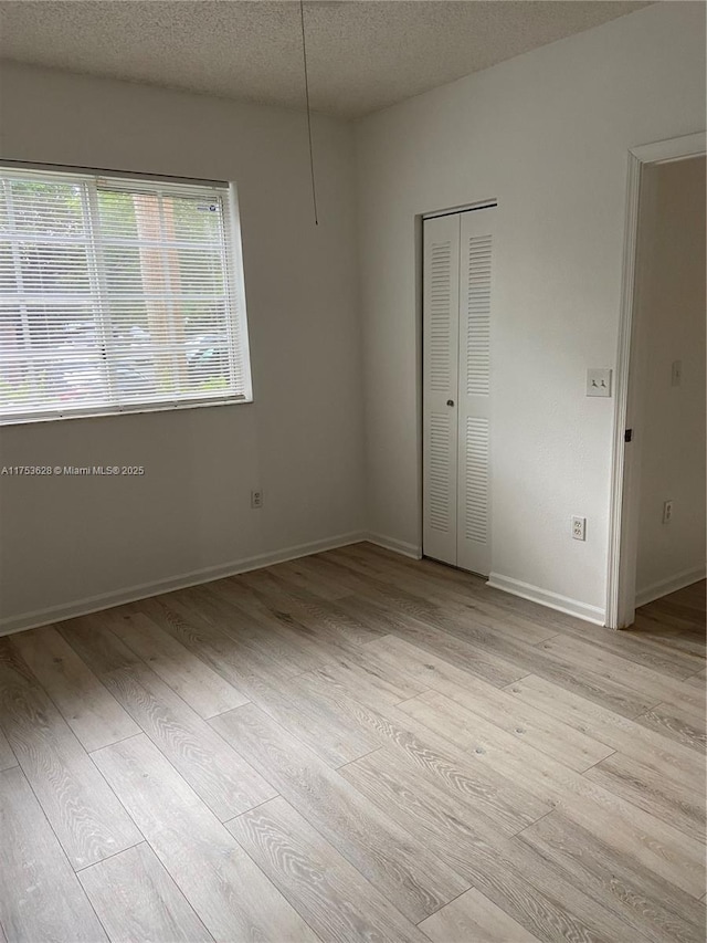 3231 Sabal Palm Mnr Unit 101, Davie, FL 33024 - spare room with light wood finished floors and a textured ceiling