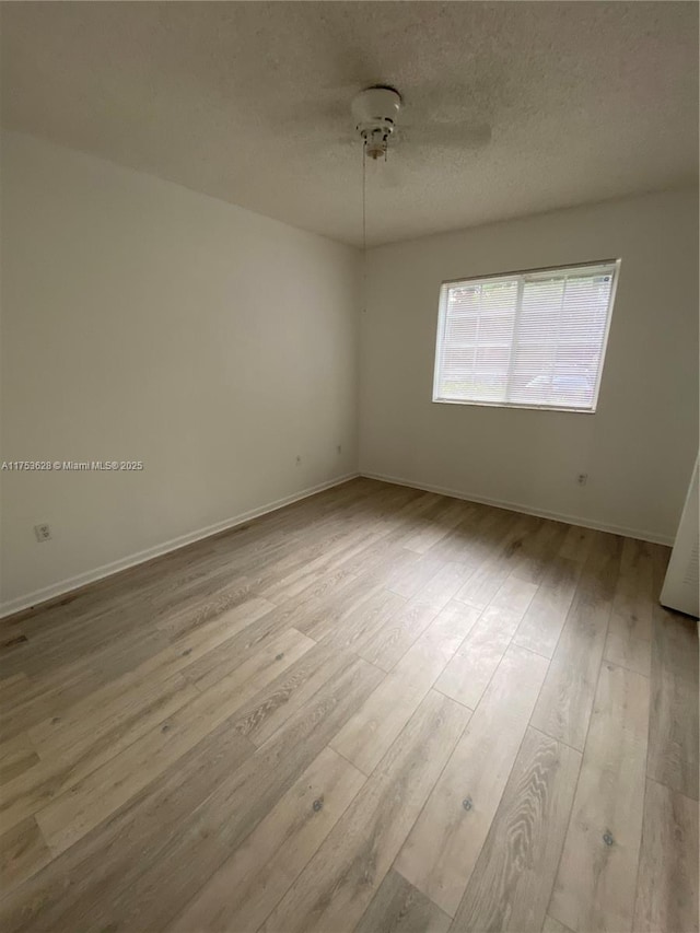 3231 Sabal Palm Mnr Unit 101, Davie, FL 33024 - empty room featuring wood finished floors and a textured ceiling