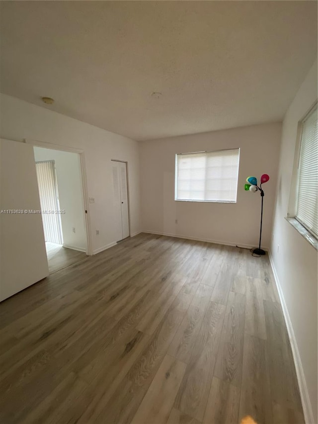 3231 Sabal Palm Mnr Unit 101, Davie, FL 33024 - unfurnished room featuring wood finished floors and baseboards