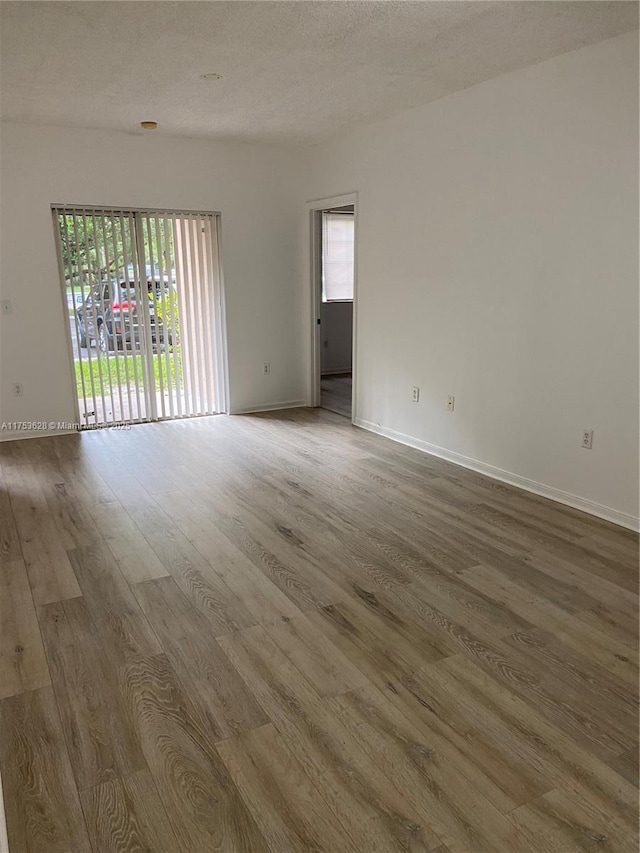 3231 Sabal Palm Mnr Unit 101, Davie, FL 33024 - empty room featuring wood finished floors and baseboards