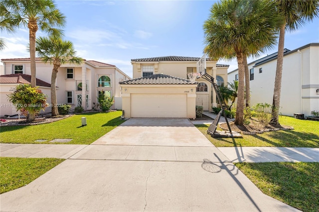 mediterranean / spanish-style home with stucco siding, driveway, a tile roof, a front yard, and a garage