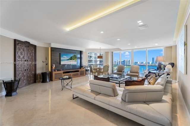 living area featuring a wall of windows, a view of city, and recessed lighting