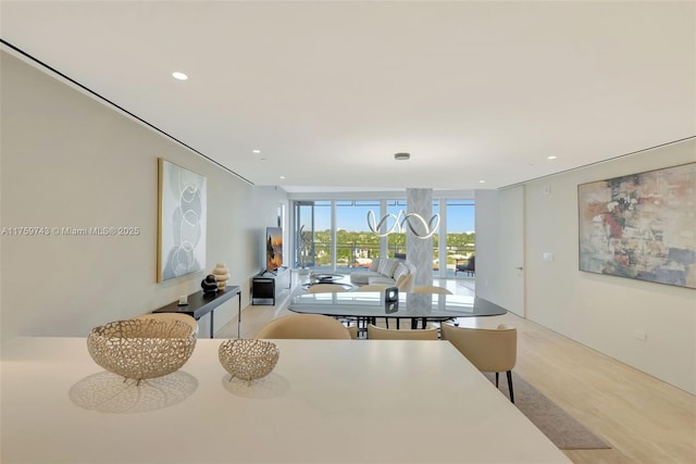 dining space featuring recessed lighting and a wall of windows