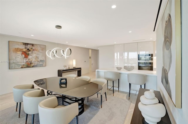 dining room featuring recessed lighting and light wood-style floors