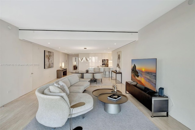 living area with recessed lighting and light wood-style floors