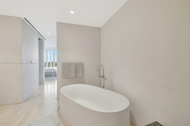 ensuite bathroom with recessed lighting, ensuite bathroom, and a freestanding tub