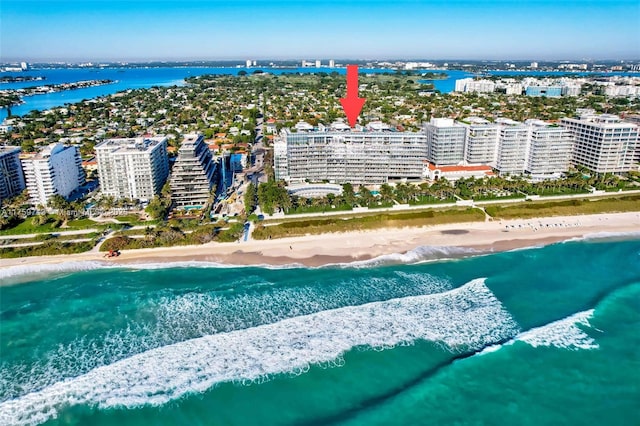 aerial view featuring a water view, a view of city, and a beach view