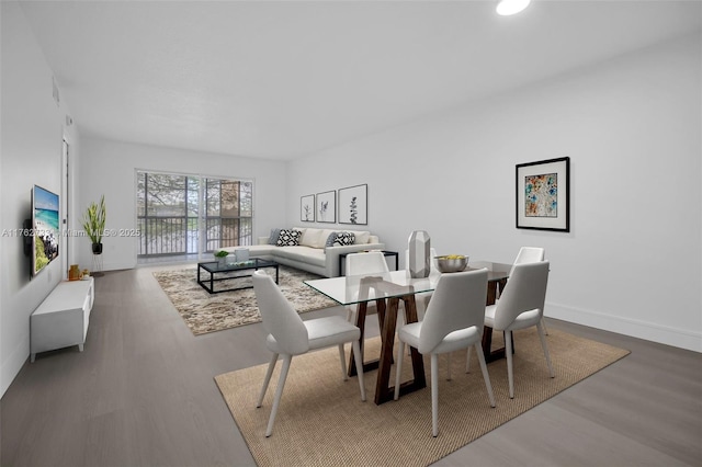 dining area featuring baseboards and wood finished floors