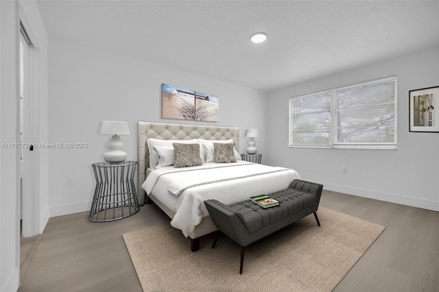 bedroom featuring light wood-type flooring and baseboards