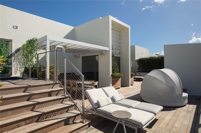 wooden terrace with stairway and outdoor dining space