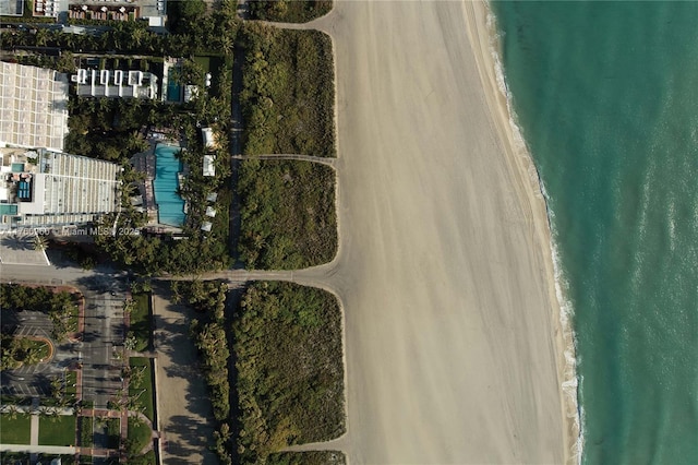 drone / aerial view with a water view and a beach view