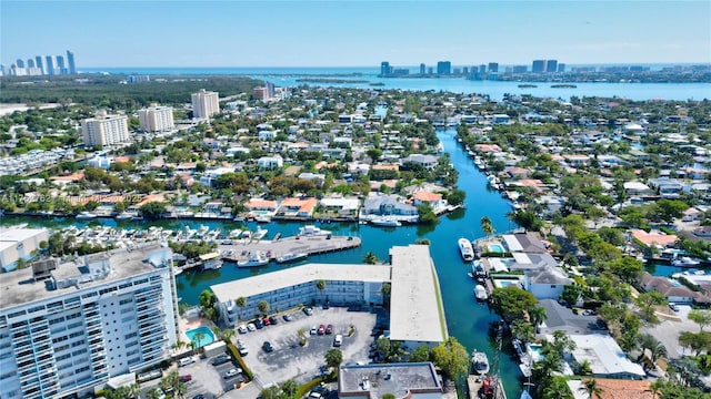 birds eye view of property featuring a city view and a water view