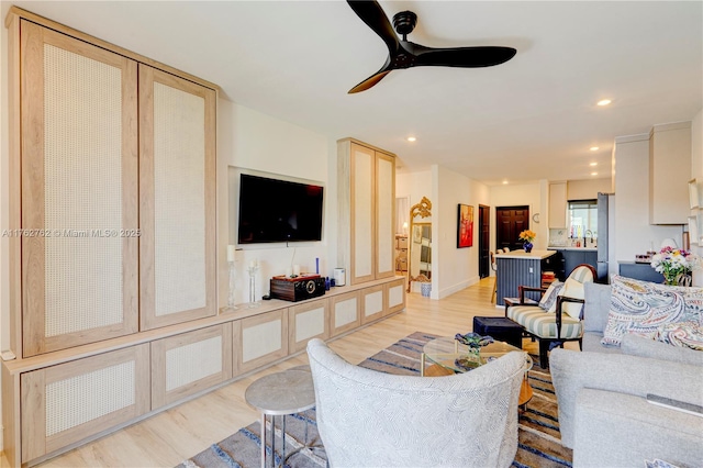 living room featuring recessed lighting, baseboards, light wood-style floors, and ceiling fan