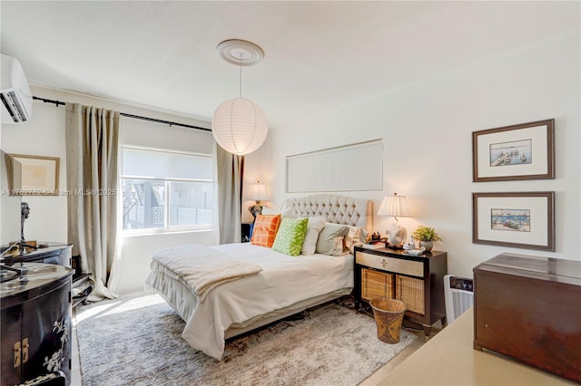 bedroom featuring an AC wall unit