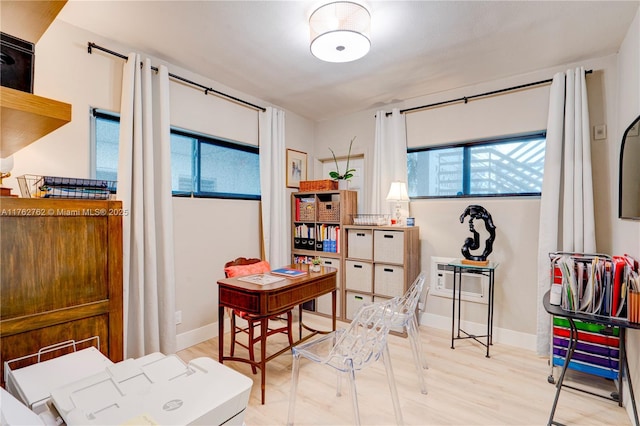 office area featuring light wood-style floors and baseboards