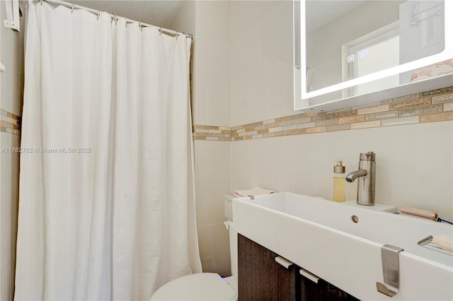 bathroom featuring vanity, tile walls, toilet, and a shower with curtain