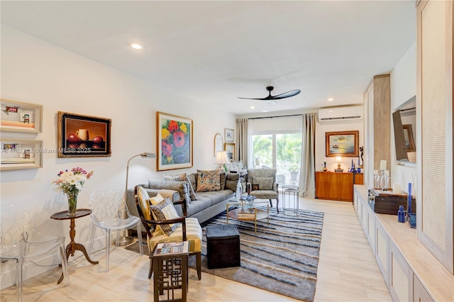 living area with recessed lighting, light wood-style floors, ceiling fan, and a wall mounted AC