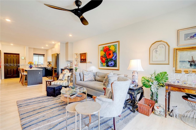 living room featuring light wood-style flooring, recessed lighting, and ceiling fan